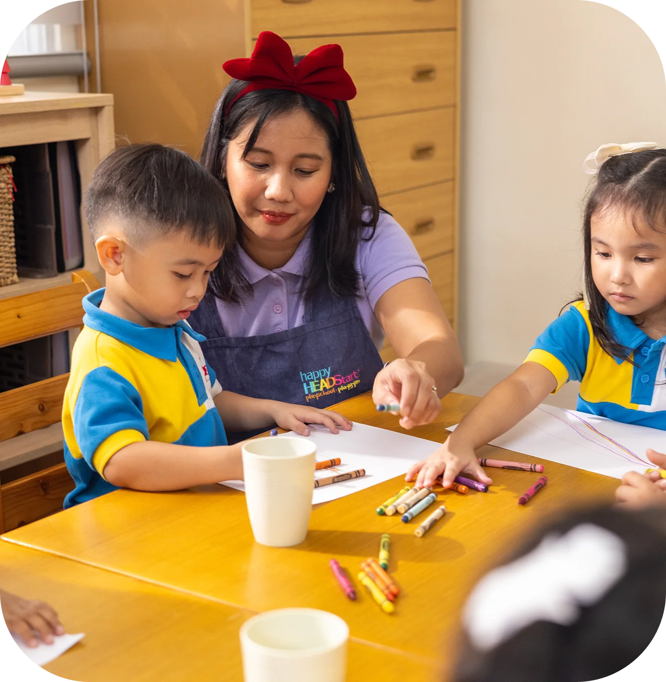 Happy Head Start students engaged in indoor activities